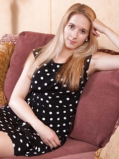 Naomi Is Posing On Her Couch In Her Black Dress, Wearing Provocative Red Undie Underneath