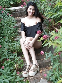 Ornella Sits In Her Back Yard Smiling, And In Her New Black Gown
