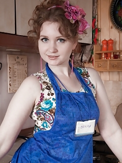 Bazhena Is Falling Around In Her Kitchen In Her Blue Pinafore And Nubile Dress